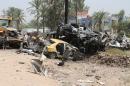 Iraqis inspect the site of a suicide bomb attack at the entrance to the town of Khales, northeast of Baghdad, on July 25, 2016