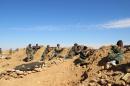 Syrian army soldiers take positions on the outskirts of Syria's Raqa region