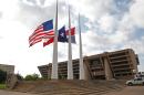 Flags fly at half mast at Dallas City Hall following the fatal shootings of five police officers on July 8, 2016