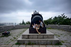 Two boys rest behind a cannon as they visit a fort&nbsp;&hellip;