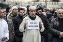 A Muslim man holds a sign reading "Not in my name", during a gathering on January 9, 2015 near the mosque of Saint-Etienne, eastern France, after the attack on the offices of weekly satirical Charlie Hebdo