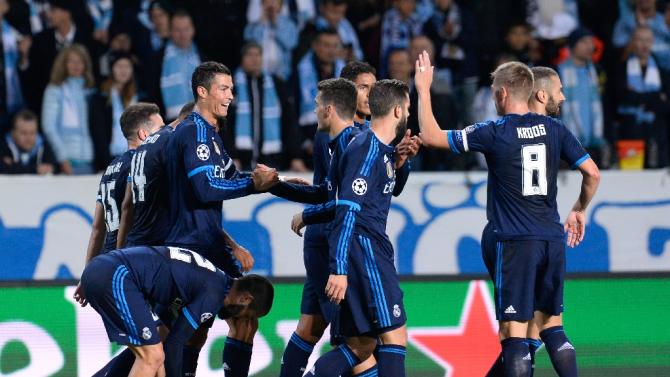 Real Madrid&#39;s forward Cristiano Ronaldo celebrates after scoring the opening goal with his teammates during the UEFA Champions League first-leg Group A football match between Malmo FF and Real Madrid CF in Malmo, Sweden on September 30, 2015