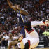 Miami Heat forward Udonis Haslem, foreground, is upended as he goes up for a shot against Memphis Grizzlies guard O.J. Mayo during the first half of an NBA basketball game, Friday, April 6, 2012 in Miami. (AP Photo/Wilfredo Lee)