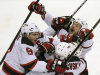 New Jersey Devils' Zach Parise (9), Alexei Poonikarovsky (12), Marek Zidlicky (2) and David Clarkson, top right, mob Adam Henrique, obsucred, after he scored during the second overtime against the Florida Panthers in Game 7 in a first-round NHL Stanley Cup playoff hockey series in Sunrise, Fla., Wednesday, April 26, 2012. The Devils won 3-2. (AP Photo/J Pat Carter)