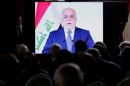 FILE PHOTO: Iraqi Prime Minister Haider al-Abadi is seen on a screen as he speaks via a videoconference during a ministerial summit to hold discussion on the future of Mosul city, post-Islamic State, in Paris