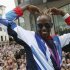 Long distance runner Mo Farah makes his trademark "Mobot" pose during a parade of British Olympic and Paralympic athletes through London