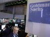 Traders work at the Goldman Sachs stall on the floor of the New York Stock Exchange