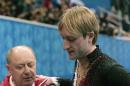 Evgeni Plushenko of Russia, right, and his coach Alexei Mishin leave after Plushenko pulled out of the men's short program figure skating competition due to illness at the Iceberg Skating Palace during the 2014 Winter Olympics, Thursday, Feb. 13, 2014, in Sochi, Russia. (AP Photo/Ivan Sekretarev)