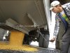 FILE - In this file photo taken Oct. 13, 2010, central Illinois farmer Adam Wallace unloads harvested corn from his truck at Archer Daniels Midland Curran Grain Elevator near Curran, Ill. Agribusiness conglomerate Archer Daniels Midland said Tuesday, Aug. 2, 2011, its fiscal fourth-quarter earnings fell 15 percent as a higher tax rate offset surging revenue. (AP Photo/Seth Perlman, File)