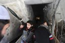 Fighters from Fateh al Sham unit of the Free Syrian Army enter a house in Haresta neighbourhood of Damascus