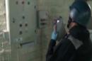 An image grab taken from Syrian television shows an inspector from the Organisation for the Prohibition of Chemical Weapons (OPCW) at work at an undisclosed location in Syria on October 8, 2013