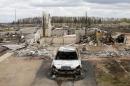 A charred vehicle and home are pictured in the Beacon Hill neighbourhood of Fort McMurray, Alberta, Canada, May 9, 2016 after wildfires forced the evacuation of the town