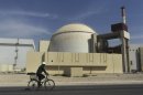 FILE - In this Tuesday, Oct. 26, 2010 file photo, a worker rides a bike in front of the reactor building of the Bushehr nuclear power plant, just outside the southern city of Bushehr, Iran. While much is known about Iran's nuclear activities from U.N. inspection visits, significant questions remain uncertain, fueling fears of worst-case scenarios and calls for new Mideast military action.(AP Photo/Mehr News Agency, Majid Asgaripour, File)