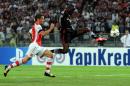 Besiktas' Demba Ba (R) vies with Arsenal's Laurent Kaschielny (L) during the UEFA Champions League play-off football match Besiktas vs Arsenal at Ataturk Olympic Stadium on August 19, 2014 in Istanbul