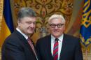 German Foreign Minister Frank-Walter Steinmeier shakes hands with Ukrainian President Petro Poroshenko, left , during a meeting in Kiev, Ukraine, Tuesday June 24, 2014. Steinmeier visited Ukraine on Tuesday to discuss the situation in the east of the country and an EU Association agreement that Ukraine is due to sign in Brussels on June 27. (AP Photo/Mykhailo Markiv, Pool)