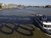 A passenger boat passes a reflection of Olympic rings on the River Thames in London,  Monday, July 23, 2012. The summer Olympics in London will start on Friday July 27. (AP Photo/Kirsty Wigglesworth)