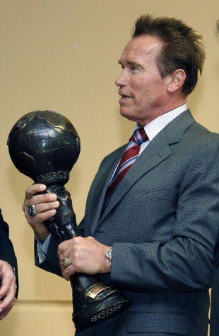 Austrian born actor and former Governor of California Arnold Schwarzenegger holds the Energy Globe Award he received during a press conference in Guessing in the province of Burgenland, Austria, on Sunday, Jan. 22, 2012. (AP Photo/Ronald Zak)