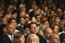 Britain's PM, David Cameron, listens as Chancellor of the Exchequer, George Osborne, delivers his speech at the Conservative Party's annual conference in Birmingham