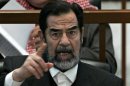 Ousted Iraqi President Saddam Hussein reacts in court during the Anfal genocide trial