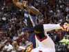 Miami Heat forward Udonis Haslem, foreground, is upended as he goes up for a shot against Memphis Grizzlies guard O.J. Mayo during the first half of an NBA basketball game, Friday, April 6, 2012 in Miami. (AP Photo/Wilfredo Lee)