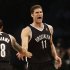 Brooklyn Nets' Brook Lopez, right, reacts after scoring against the Chicago Bulls during the first quarter of Game 1 of a first-round series of the NBA basketball playoffs, Saturday, April 20, 2013, in New York. (AP Photo/Seth Wenig)