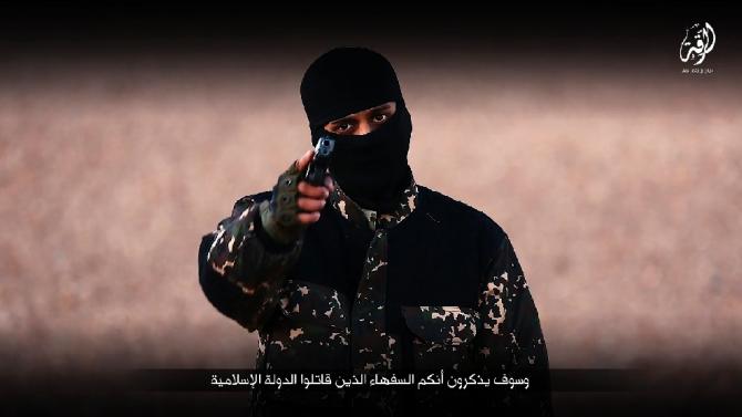 An image grab taken from a video published by media branch of Islamic State group on January 3, 2016, purportedly shows an English-speaking IS fighter speaking at an undisclosed location before executing five men from the Syrian city of Raqa