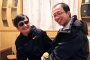 Outspoken government critic Hu Jia (R) sharing a light moment with blind lawyer Chen Guangcheng after his escape