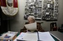 In this Nov. 26, 2012 photo, journalist and radio host Maria Julia Venegas, better known as Maruja Venegas, 97, reads during an interview at her home in Lima, Peru. Venegas who began broadcasting 