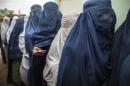 Afghan women stand in line while waiting for their turn to vote at a polling station in Mazar-i-sharif