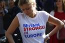 A woman wearing a vote remain tee-shirt reacts, following the result of the EU referendum, in London