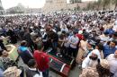 Libyans mourn next to the coffins of two fighters from the Islamist-backed Fajr Libya militia alliance during their funeral on April 18, 2015 in Tripoli's landamark Martyrs square, a day after they were killed in clashes in Tajoura