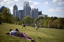 FILE - In this March 25, 2012, file photo a couple enjoy a sunny afternoon against the backdrop of the Midtown skyline from Piedmont Park in Atlanta. The lower 48 states were 8.6 degrees above normal for March and 6 degrees higher than average for the first three months of the year, according to calculations by the National Oceanic and Atmospheric Administration, with both March and the first three months of the year far exceeding the country's old records.(AP Photo/David Goldman)