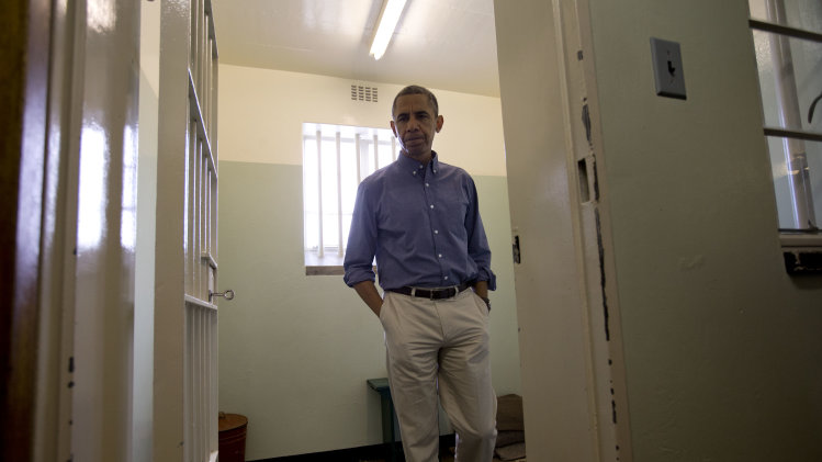 RETRANSMISSION TO CORRECT SPELLING OF PRESIDENT'S FIRST NAME - U.S. President Barack Obama walks from Section B, prison cell No. 5, on Robben Island, South Africa, Sunday, June 30, 2013. This was former South African president Nelson Mandela's cell, where he spent 18-years of his 27-year prison term on the island locked up by the former apartheid government. (AP Photo/Carolyn Kaster)
