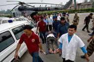 An Indian pilgrim is evacuated by medics at the Jolly Grant Airport in Dehradun, Uttarakhand, on June 21, 2013. Distraught relatives clutching photographs of missing family members have been waiting for days outside Dehradun airport hoping for news of their loved ones