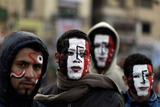 Egyptians wear face paint in the colors of the national flag in Tahrir Square as thousands gather to mark the one year anniversary of the uprising that ousted President Hosni Mubarak in Cairo, Egypt, 