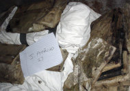 This 2003 file photo shows books and documents found by U.S. troops in a secret police building in Baghdad. A trove of Jewish books and other materials, rescued from a sewage-filled Baghdad basement during the 2003 invasion and now stored at the National Archives and Records Administration in College Park, Md. near Washington, is now caught up in a tug-of-war between the U.S. and Iraq. (AP Photo/Maj. Corine Wegener, File)