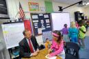 Delaware Gov. Jack Markell, left, helps third-grader Raegan Megahan with a math lesson at Silver Lake Elementary School in Middletown, Del., Tuesday, Oct. 1, 2013. Silver Lake has begun implementing the national Common Core State Standards for academics. (AP Photo/Steve Ruark)