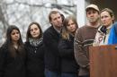 Family members of victims killed in the Sandy Hook Elementary School shooting listen to a statement about the formation of the website mysandyhookfamily.org created for victim's families in Sandy Hook