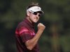 Poulter of England celebrates on the 18th green after winning the WGC-HSBC Champions Tournament at Mission Hills in Dongguan