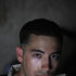 In this Monday, Sept. 5, 2011, photo, U.S. Marine Jorge Pedroza, of Long Beach, Calif., poses for a portrait at his small patrol base, in Helmand province, southern Afghanistan. Pedroza, on his memory of the Sept. 11, 2001 attack: "I was actually in the principal's office, waiting to give the morning announcements, and I saw it on the TV, and I had been there a few years earlier, and I was like 'Wow, I can't believe that actually happened. That was just crazy. School kept going, but a lot of parents came and took their kids away though." (AP Photo/Brennan Linsley)