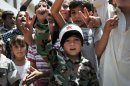 This citizen journalism image provided by Shaam News Network SNN, taken on Friday, July 6, 2012, purports to show Syrian children chanting slogans during a demonstration in Idlib, north Syria. Syria's military began large-scale exercises simulating defense against outside "aggression," the state-run news agency said Sunday an apparent warning to other countries not to intervene in the country's crisis. (AP Photo/Shaam News Network, SNN)THE ASSOCIATED PRESS IS UNABLE TO INDEPENDENTLY VERIFY THE AUTHENTICITY, CONTENT, LOCATION OR DATE OF THIS HANDOUT PHOTO