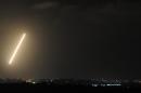 A light trail made by a rocket fired from the Gaza Strip marks the night sky on August 21, 2014