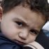 Bushr Al Tawashi looks at the photographer as he is carried by his mother Arin Al Dakkar, outside of a private Sigma TV station, in Nicosia, Cyprus, Friday, Oct. 26, 2012. Bushr Al Tawashi, a 2-year-old Syrian boy who was believed dead after his family inadvertently left him behind as they fled shelling in Damascus last summer has been reunited with his parents in Cyprus, a lawyer said. "You can imagine how they felt when they were told their son was alive after bearing all this guilt thinking that he was dead," lawyer Stella Constantinou told The Associated Press. (AP Photo/Petros Karadjias)