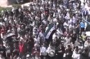 This image made from amateur video released by the Shaam News Network and accessed Thursday, April 12, 2012, purports to show Syrians chanting slogans during a demonstration in Idlib, Syria. Syrian forces halted attacks on opposition strongholds Thursday in line with a U.N.-brokered truce but the regime defied demands by international envoy Kofi Annan to pull troops back to their barracks, activists said. (AP Photo/Shaam News Network via AP video) TV OUT, THE ASSOCIATED PRESS CANNOT INDEPENDENTLY VERIFY THE CONTENT, DATE, LOCATION OR AUTHENTICITY OF THIS MATERIAL