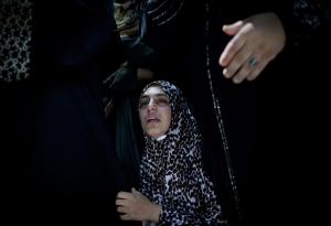 A Palestinian girl cries while mourners carry the body &hellip;