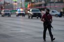 A member of the local police in plain clothes patrols in Ciudad Juarez, Mexico, on May 7, 2013