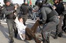 Russian riot police detain a participant during a 