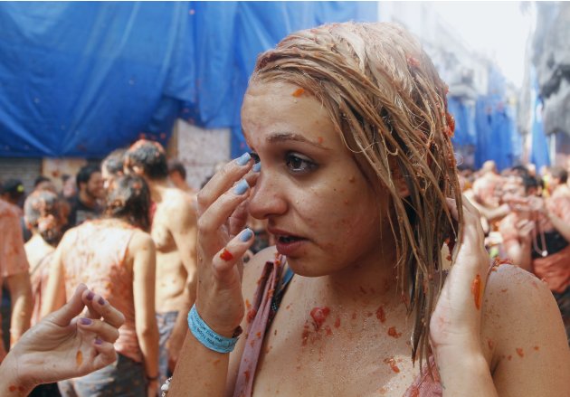 A reveller leaves the "battlefield" after the annual "Tomatina" (tomato fight) in the Mediterranean village of Bunol, near Valencia