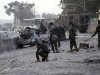 Afghan National Army soldiers inspect the site of a car bomb attack in Jalalabad province