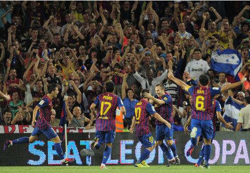 FC Barcelona's Andres Iniesta, second right, reacts after scoring against Real Madrid during his Super Cup final second leg soccer match at the Camp Nou Stadium in Barcelona, Spain, Wednesday, Aug. 17, 2011. (AP Photo/Manu Fernandez)
